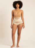 Model wearing YACO CurveFit beige high-waisted shaping bottoms with breathable mesh panels for a smooth silhouette.