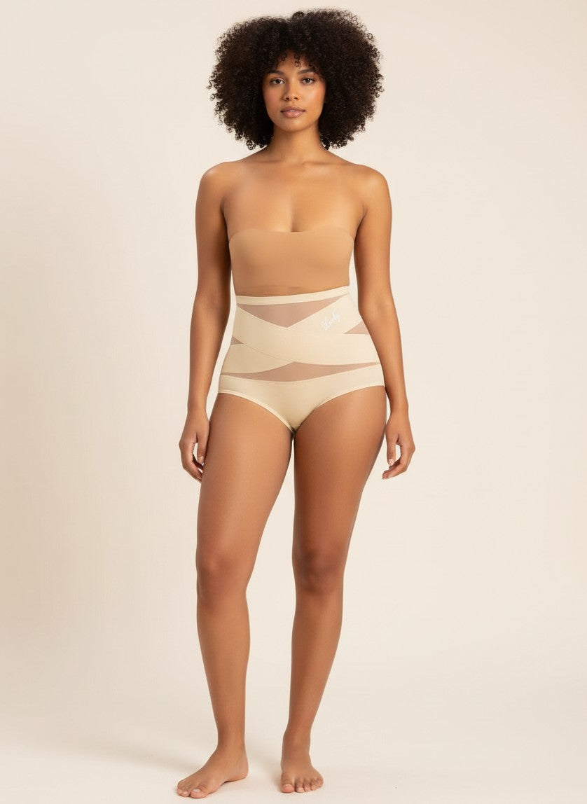 Model wearing YACO CurveFit beige high-waisted shaping bottoms with breathable mesh panels for a smooth silhouette.